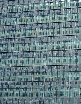 Abstract green reflections in the windows of a skyscraper.