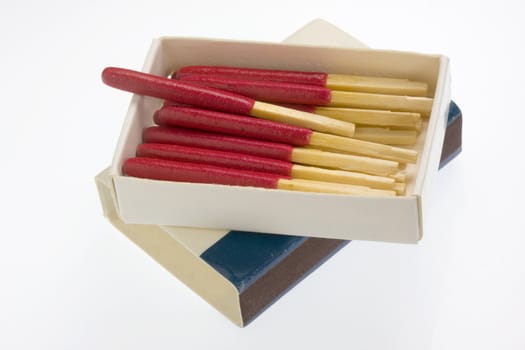 open box of waterproof matches with long red heads, white background
