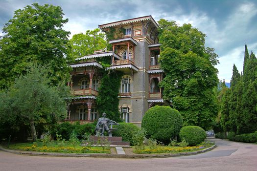 Sanatorium building in Gurzuf (Crimea Ukraine). The monument to Lenin is in a foreground.