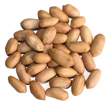 Pile of peeled raw peanuts isolated over a white background.