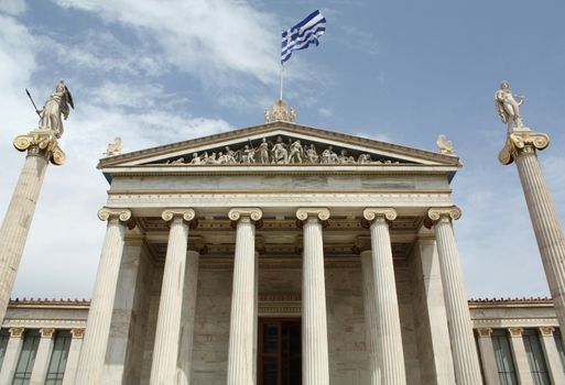 Academy of Athens with ionic columns and statues of goddess Athena and god Apollo.