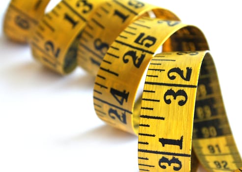 Yellow measuring tape isolated over a white background.