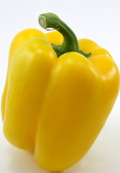 Single fresh yellow organic pepper, on white back