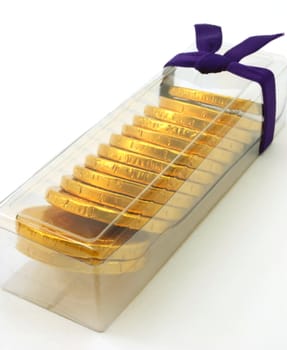 Gift pack of chocolate gold coins, angled portrait view
