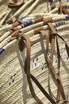 This is a stack of wicker bags with leather handles.