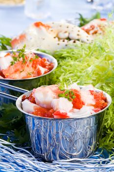 Crab meat in silver pot with green salade