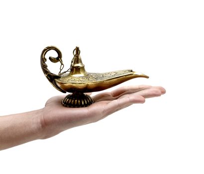 A magic genie lamp on a persons hand, isolated on white.