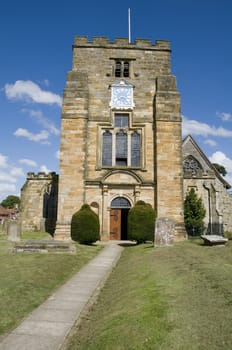 A rural church with clock tower and blue sky