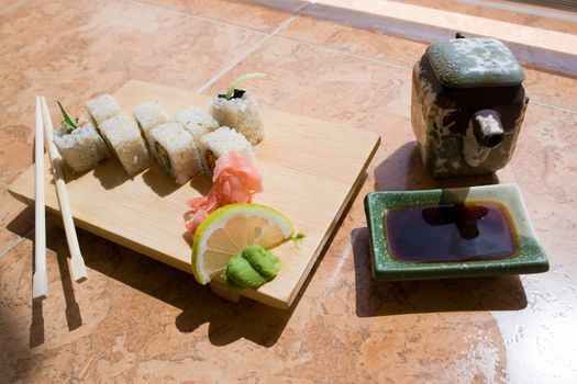 japanese sushi. Traditional wooden plate and chopsticks.