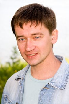 Beautiful smiling man outdoor. The face close up.