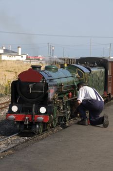 A man working on a miniature steam train