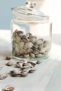 Some dried apricot stones and glass jar