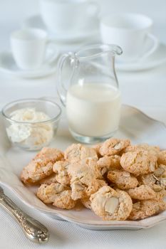 Meringue cookies on the plate and milk