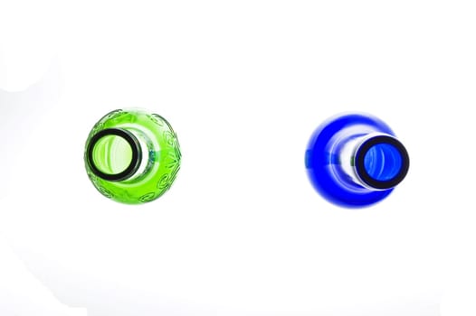 Blue and green bottles on white background