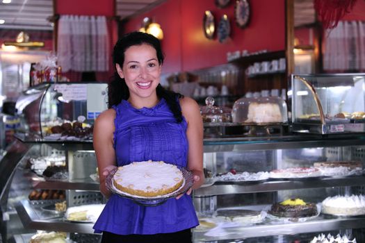 owner of a small business store showing her tasty cakes