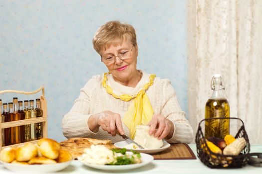 Happy senior woman cooking in the kitchen