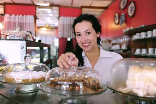 owner of a small business store showing her tasty cakes