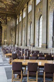 The interior of a great hall with tables and chairs