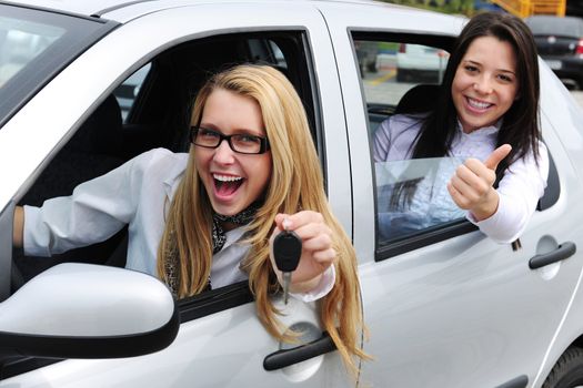 car rental: women driving a new car
