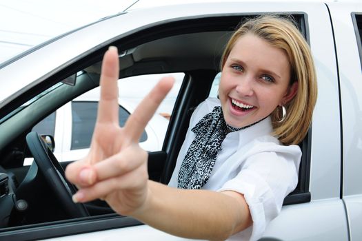 happy woman driving a new car