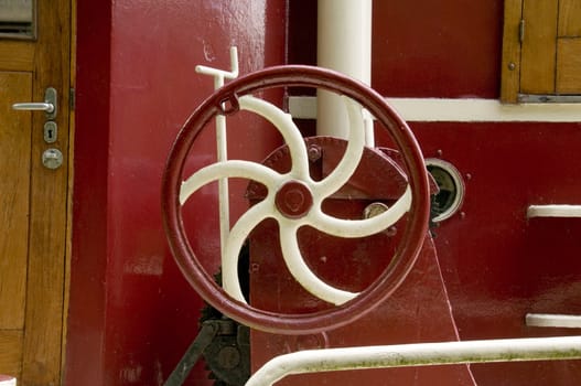 A painted metal wheel on a boat