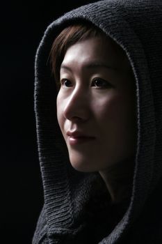 Asian Woman In Deep Thoughts - Hood Over Head - Black Background