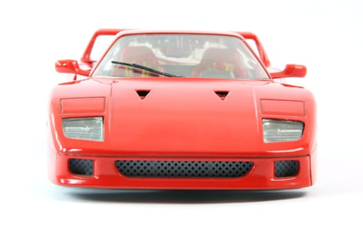 front from red sports car miniature isolated on white background