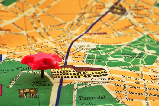 Close-up of a pink pin on a map of Rome