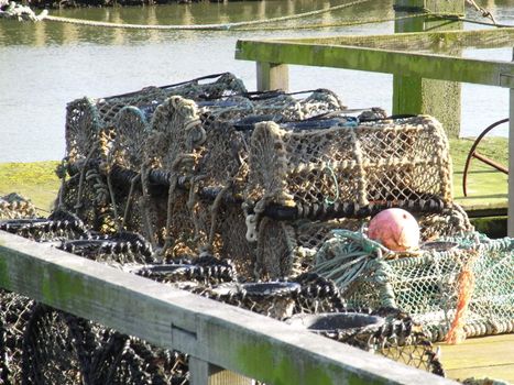 lobster pots sitting on the quay.