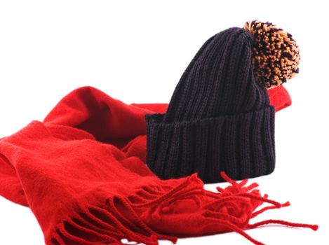 Red scarf and woolen ski cap isolated on white