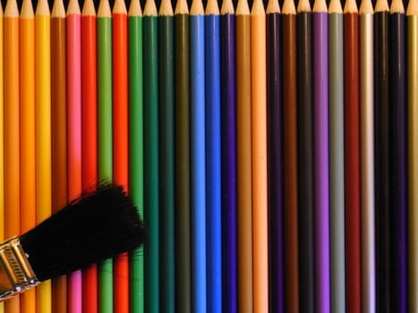 coloured pencils with paintbrush.