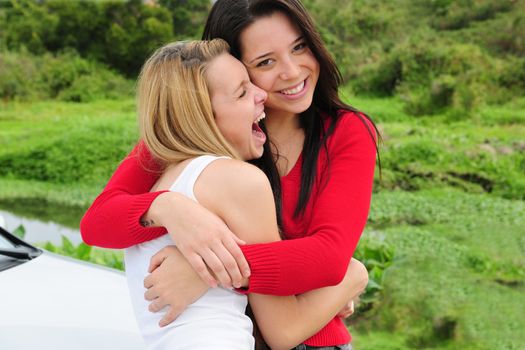 two happy women on car trip