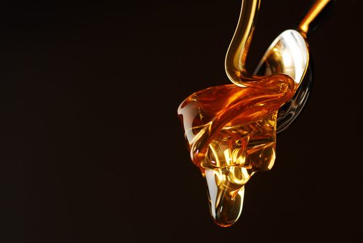 Golden honey dropping stock photo