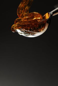 Honey being poured into a spoon stock photo