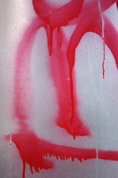 Abstract red airbrush graffiti on a metallic surface