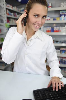 pharmacist using computer and telephone