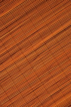 Oriental rattan mat texture of sunny orange color.