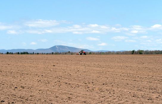 Rural landscape. Tractor plowing land in spring.