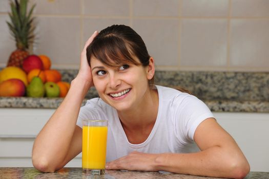 woman drinking fruit juice in the kitchen