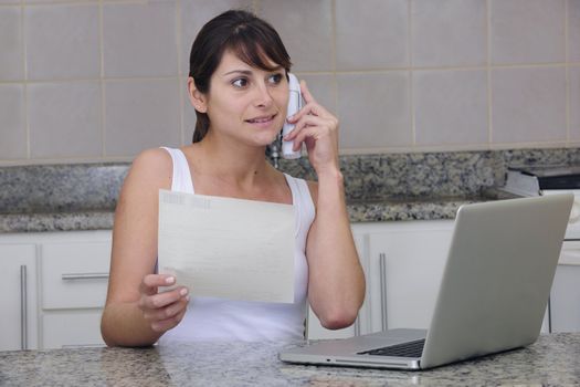 woman shopping online, talking on the phone