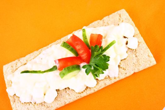 A healthy sandwich with tomato green and red vegetables