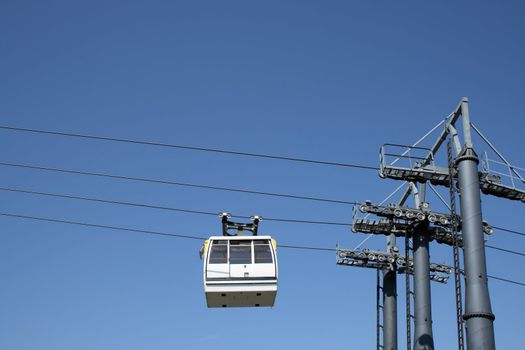 White cable car going up to the mountain.