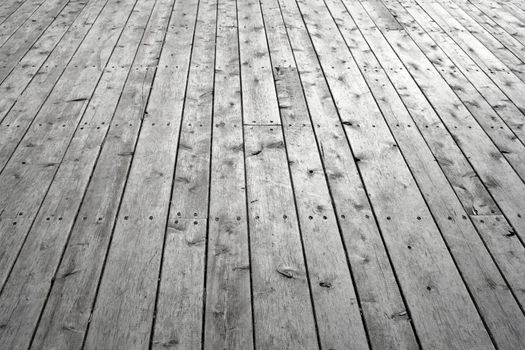 Unpainted wooden floor. Gray knotty wooden planks.