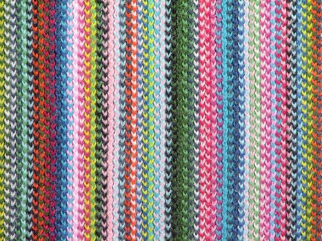 Colorful textile background. Closeup of a vivid knitted scarf.