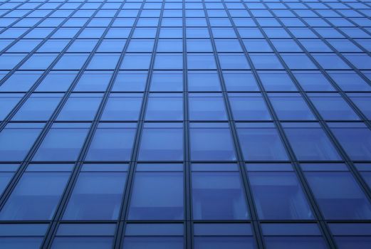 Glass panels - blue windows of a skyscraper.