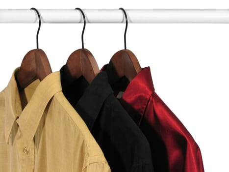 Clothing. Yellow, black and red shirts on a rack, on white background.