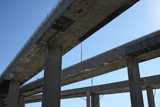 Side view of urban highway viaducts against the blue sky.
