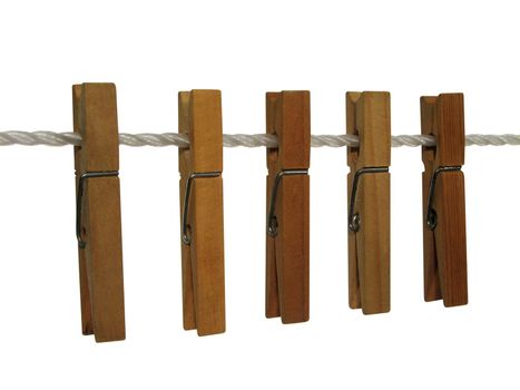 Wooden clothespins on a clothes line, isolated on white. Contains clipping path.