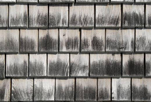 Wooden tiles pattern. Detail of an old house wall.