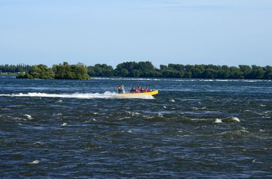 Tourists in a jet boat in a rapid stream. 